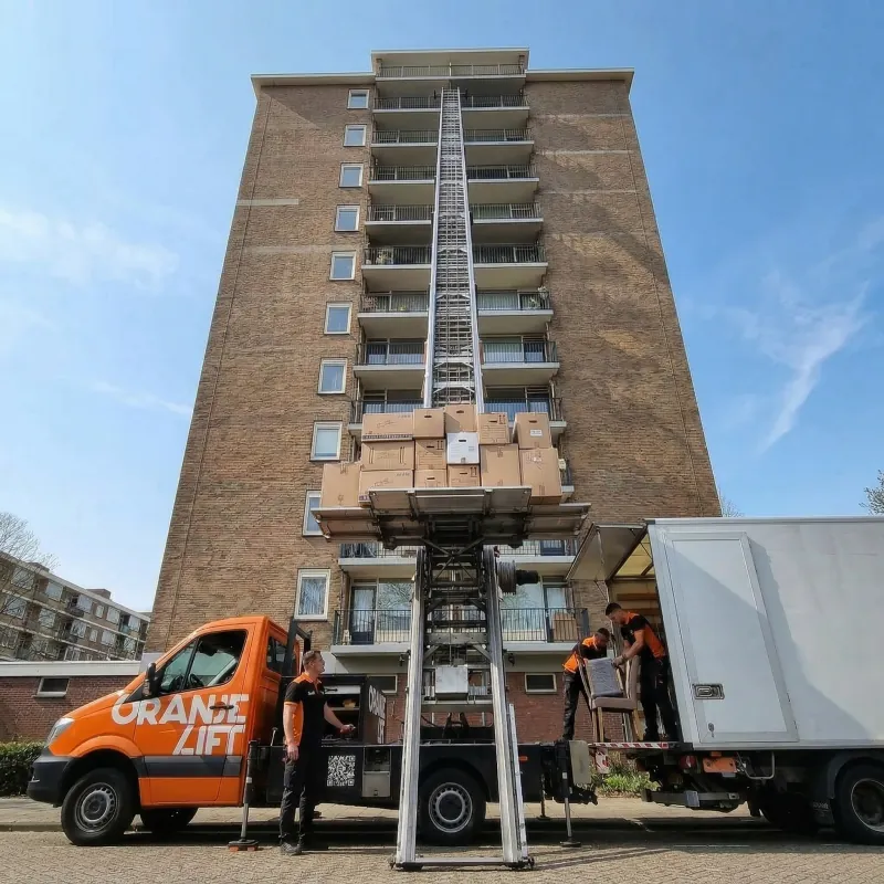OranjeLift ladderlift bij flat met verhuisdozen